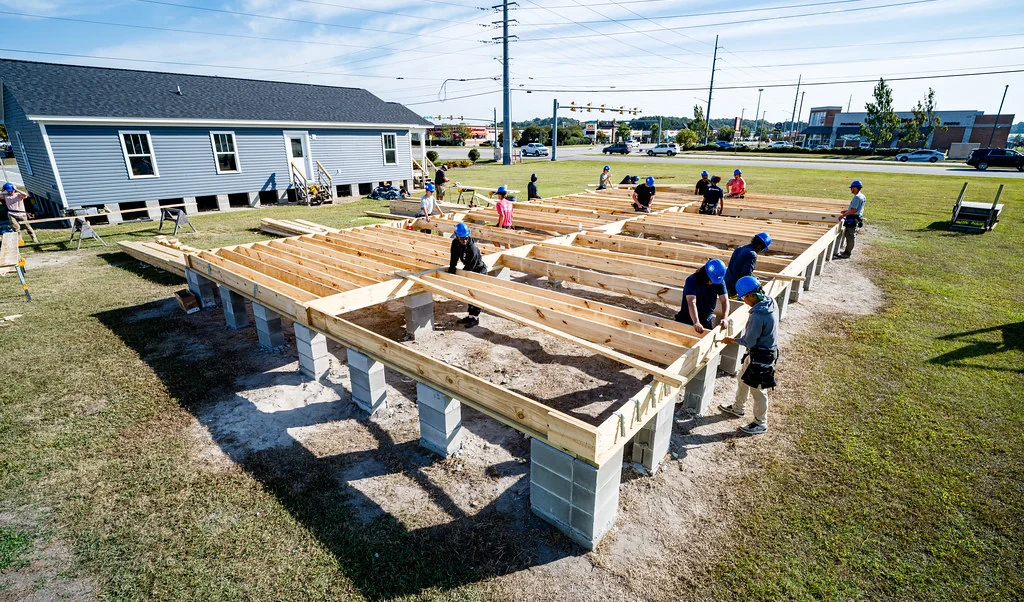 Deck joists framed across concrete pier blocks